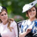 Pricess Beatrice and Princess Eugenie riding in a carriage
