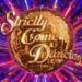 colourful explosion behind the Strictly Come Dancing golden glitter ball