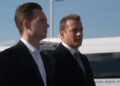 Mike Ross and Harvey Specter standing next to one another with Ross in the foreground