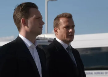 Mike Ross and Harvey Specter standing next to one another with Ross in the foreground