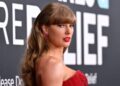 Taylor Swift posing on a red carpet.