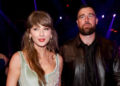 Taylor Swift and Travis Kelce standing together at the Dolby Theatre in Los Angeles