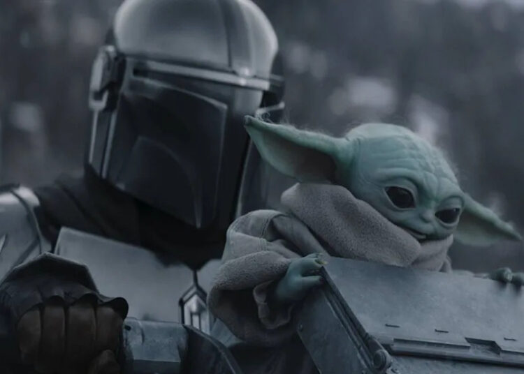 Pedro Pascal's Din Djarin and Baby Yoda in the snow in The Mandalorian and Grogu .