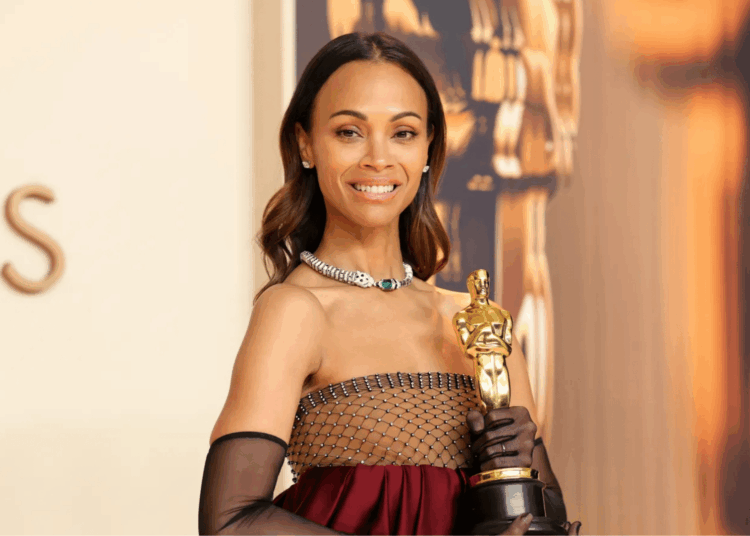 afro-latina actress poses with an Academy Award trophy at a red carpet event, celebrating her achievements in film.