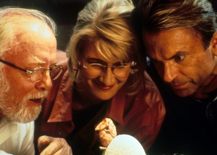 People looking at an egg.