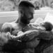 Adam Levine holding his baby