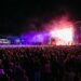 Crowds watching a lit up stage