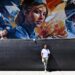 Miami-based artist Brian Peterson next to his mural at OC...