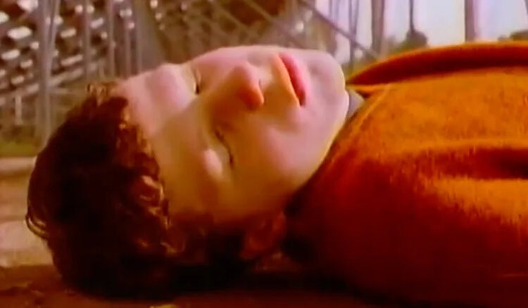 Jesse Eisenberg as Kenny lying on the ground outside in Get Real