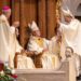 During his installation as the new bishop of Wheeling-Charleston, West Virginia, on July 2, 2026 at the Cathedral of St. Joseph in Wheeling, Bishop Evelio Menjivar-Ayala (at center) is handed the crozier, the shepherd’s staff, by Baltimore Archbishop William E. Lori (at right), as Archbishop Gabriele G. Caccia (at left), the apostolic nuncio to the United States, applauds West Virginia’s new bishop. (Catholic Standard photo by Mihoko Owada)