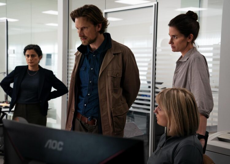 One man and four women look at a computer screen in "The Chestnut Man."