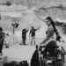 charli xcx in "camera" music video, riding a camera dolly in the desert