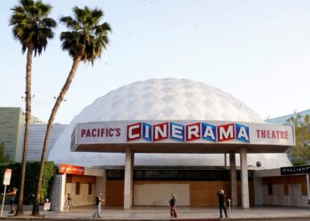 People appear outside the Cinerama Dome movie theater, April 12, 2021, in Los Angeles.  (AP Photo/Chris Pizzello)