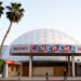 People appear outside the Cinerama Dome movie theater, April 12, 2021, in Los Angeles. (AP Photo/Chris Pizzello)