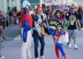 Dorian Reyes Black of Los Angeles, dressed as Peacemaker, from left, Connor Bright of Los Angeles, dressed as Archie from "Riverdale" and Emily Rose of Los Angeles, dressed as Pomni from "The Amazing Digital Circus" attend Comic-Con International on Thursday in San Diego. (AP Photo/Chris Pizzello)