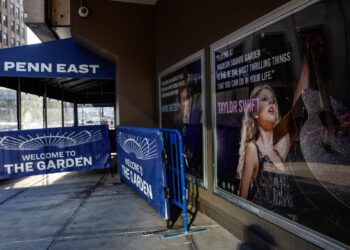 A poster featuring an image and quote from Taylor Swift is displayed outside Madison Square Garden in New York. (kena betancur / AFP via Getty Images)