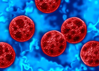 Illustration of multiple red Cyclospora cayetanensis parasites against a blue background, representing a cyclosporiasis outbreak.