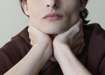Finn Wolfhard posing with head in hands