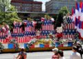 A large float with an American-themed birthday cake drives in downtown Philadelphia during the Fourth of July parade.