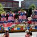 A large float with an American-themed birthday cake drives in downtown Philadelphia during the Fourth of July parade.
