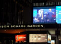 A marquee at Madison Square Garden advertising an Andrea Bocelli concert, with bright digital displays.