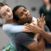 Dancers embrace during practice.