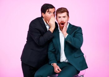 Danny Murphy and Evan Real, hosts of Page Six's "Virtual Reali-Tea," posing as if sharing a secret.