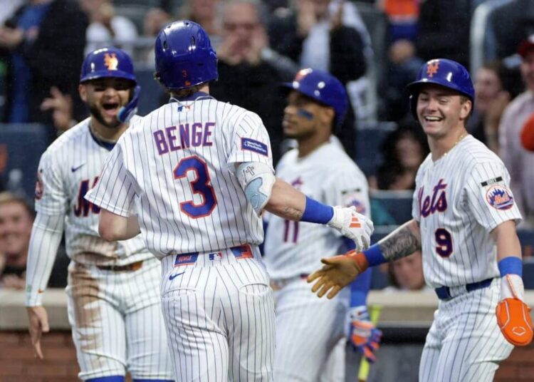 New York Mets outfielder Carson Benge celebrates with teammates during an MLB game.
