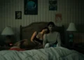 Inde Navarrette as Nikki and Michael Johnston as Bear laying in bed in