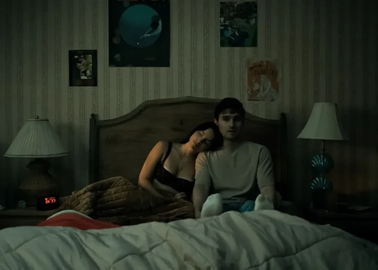 Inde Navarrette as Nikki and Michael Johnston as Bear laying in bed in