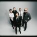 Interpol stare down AI on atmospheric new single 'Iron City'