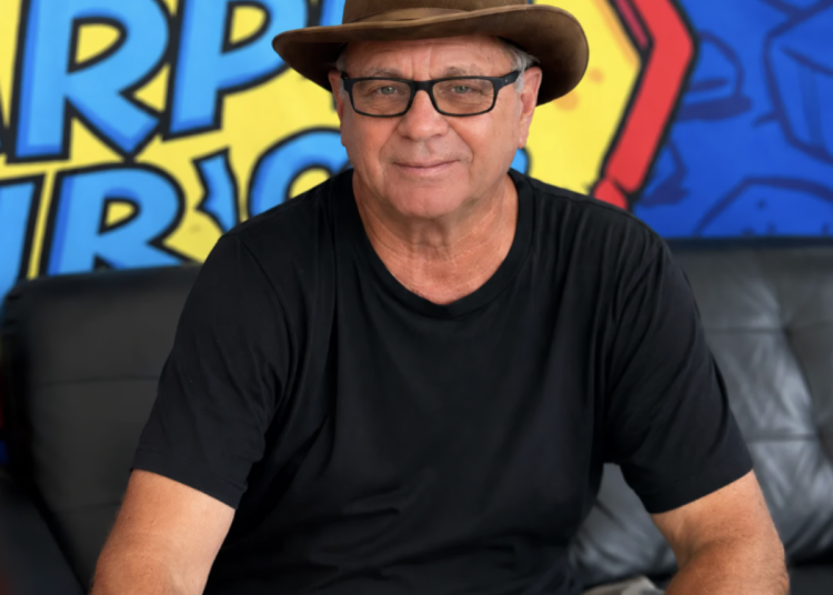Kevin Lyman sits in front of a bright background.