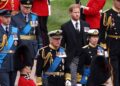 FILE - Britain's King Charles III, Princess Anne, Prince William and Prince Harry follow Queen Elizabeth II's coffin at Windsor Castle, Windsor, England in 2022.