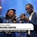 Mercy Chinwo raising her hand in worship next to Nathaniel Bassey playing the trumpet in the official Promise Keeper music video.
