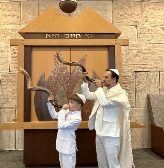 Rabbi Brian Shamash performs with his son, Ethan. The new rabbi and hazzan of Lake Success Jewish Center believes music can bring people together, deepen faith and make Jewish learning more accessible.