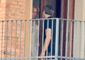 Nicole Kidman shares a farewell with a mystery man outside the suite of her Italian hotel.