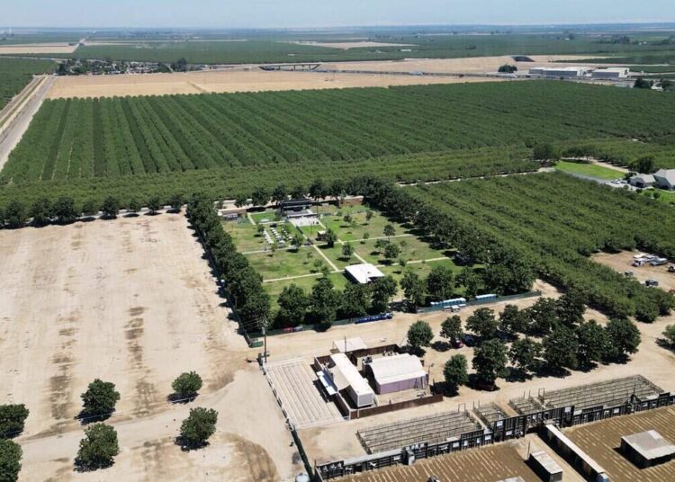 Darren Schmall’s ApCal Rock’N Ranch, the popular outdoor venue north of Fresno, photographed Friday, July 10, 2026 near Madera. Parking is seen at the bottom left along Road 32, surrounded by orchards and the main concert venue in the center.