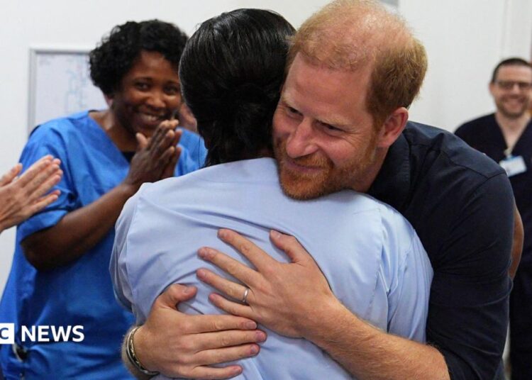 Prince Harry hugs a nurse on his visit to Birmingham Children's Hospital