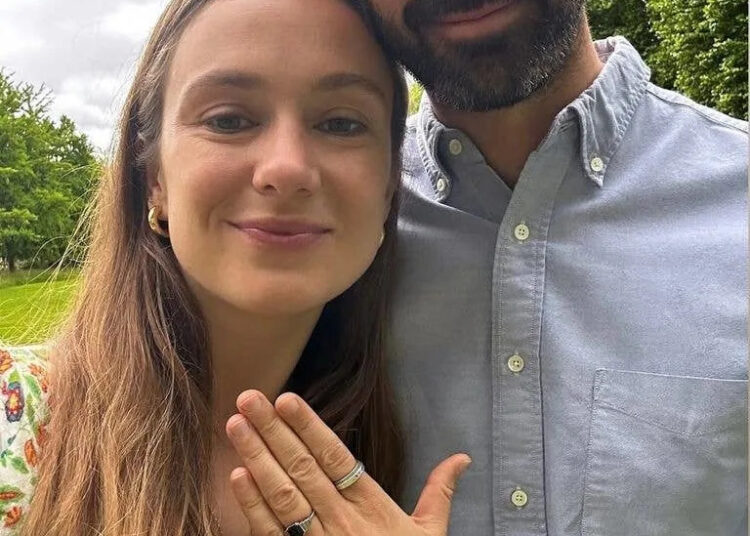 man and woman with engagement ring