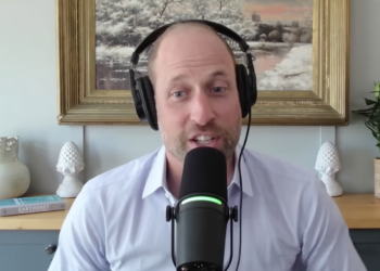 Prince William sitting in front of a mic and a painting