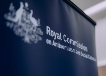 People walk into a building where police are present for the royal commission.