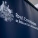 People walk into a building where police are present for the royal commission.