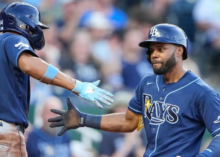 Tampa Bay Rays' Cedric Mullins, right, celebrates with Chandler Simpson (14) after hitting a two-run home run during the fifth inning of a baseball game against the Kansas City Royals, Thursday, July 2, 2026, in Kansas City, Mo. (AP Photo/Charlie Riedel)