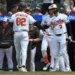 Baltimore Orioles' Jeremiah Jackson (82) is congratulated by teammate Taylor Ward (3) after scoring against the Kansas City Royals in the sixth inning of a baseball game Sunday, July 12, 2026, in Baltimore. (AP Photo/Gail Burton)