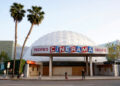 People appear outside the Cinerama Dome movie theater, April 12, 2021, in Los Angeles.  (AP Photo/Chris Pizzello, File)