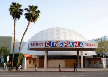 People appear outside the Cinerama Dome movie theater, April 12, 2021, in Los Angeles.  (AP Photo/Chris Pizzello, File)