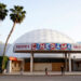 People appear outside the Cinerama Dome movie theater, April 12, 2021, in Los Angeles.  (AP Photo/Chris Pizzello, File)