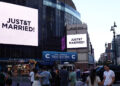A message on the video screens outside Madison Square Garden announces that Taylor Swift and Travis Kelce are married.