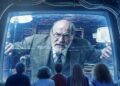 Sigmund Freud peers out of a screen at the