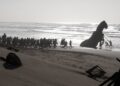 Soldiers drag the Trojan Horse out of the sea.